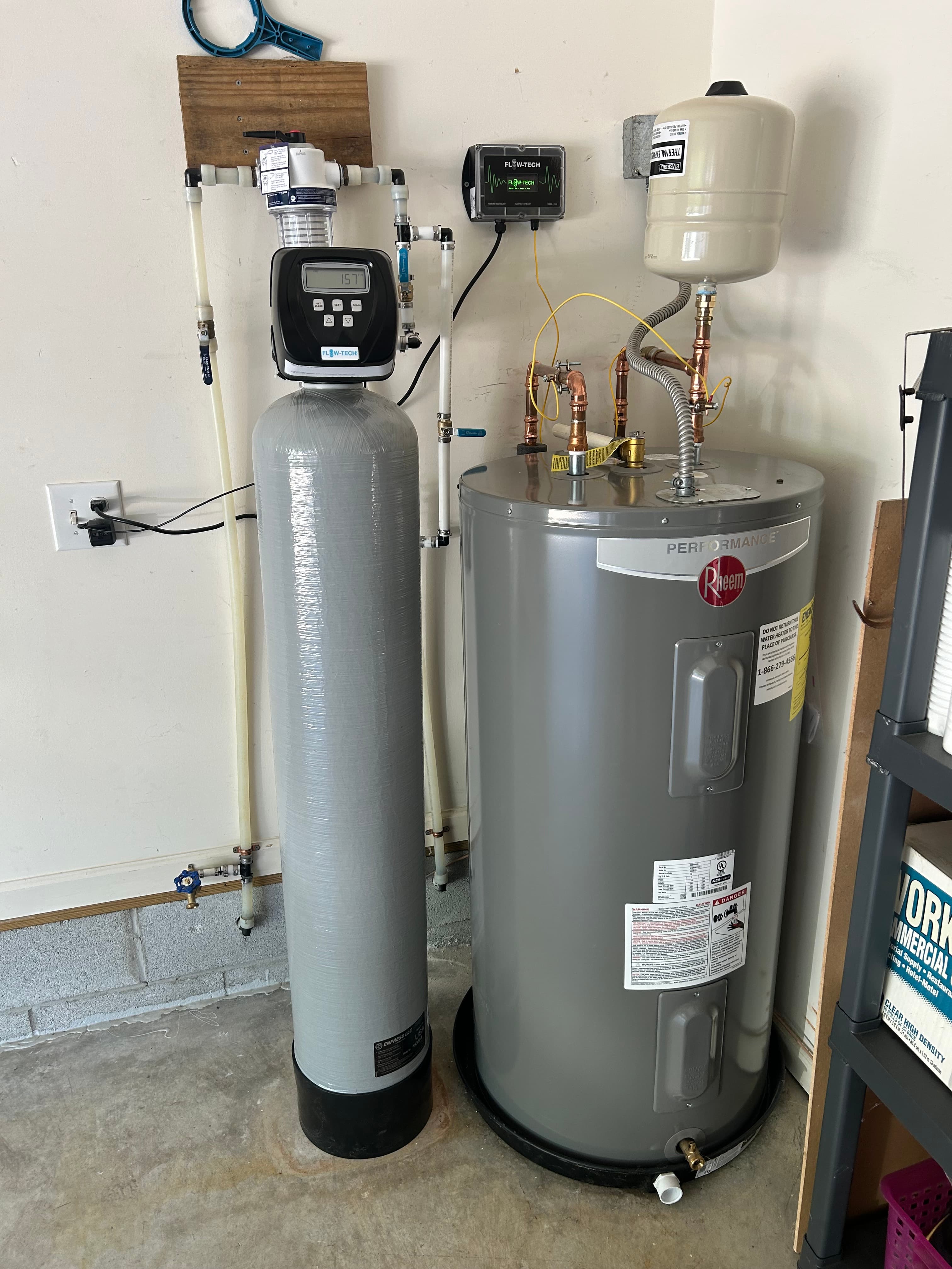 Rheem Performance water heater and Flow-Tech water softener system installed in a residential garage.